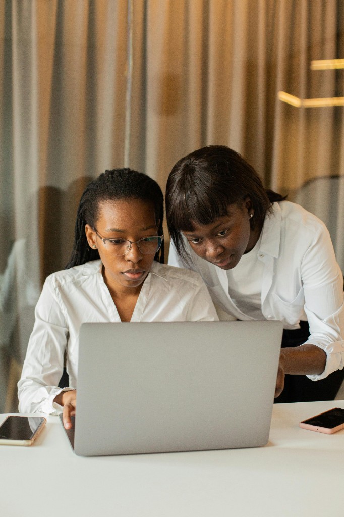 Three professional women together at a desk